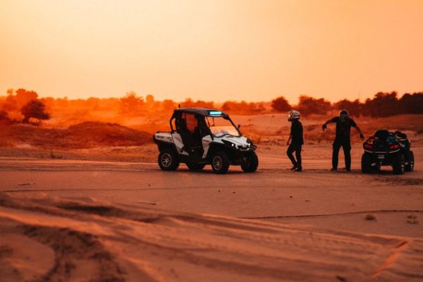 Explore the thrill of desert quad biking and dune buggy riding under the setting sun.